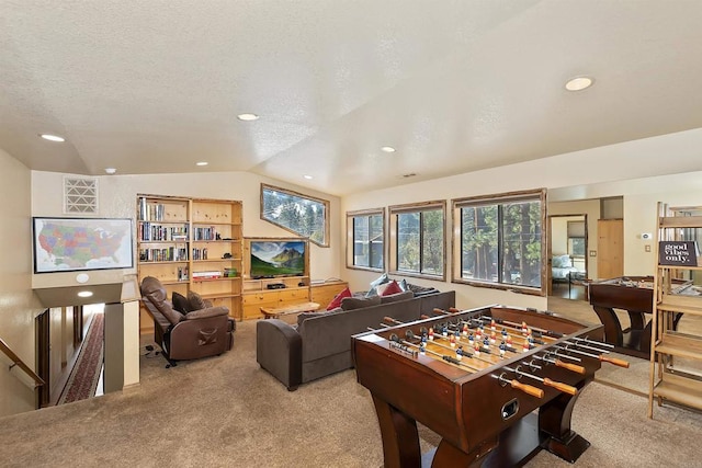 recreation room featuring light carpet, a textured ceiling, and lofted ceiling