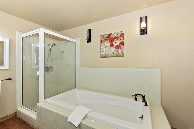 bathroom featuring hardwood / wood-style floors and plus walk in shower