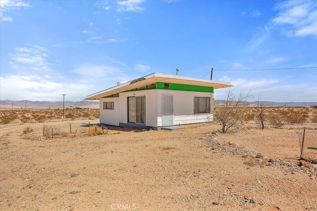 back of property featuring a mountain view