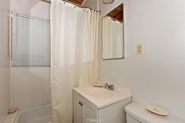 full bathroom featuring toilet, vanity, and shower / bathtub combination with curtain