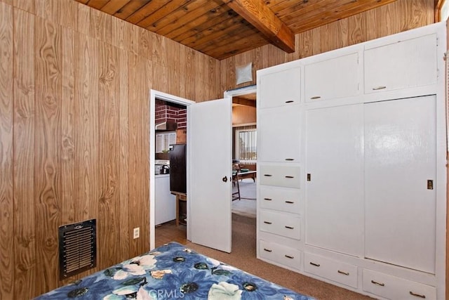 bedroom featuring carpet floors, beamed ceiling, wood walls, and wood ceiling