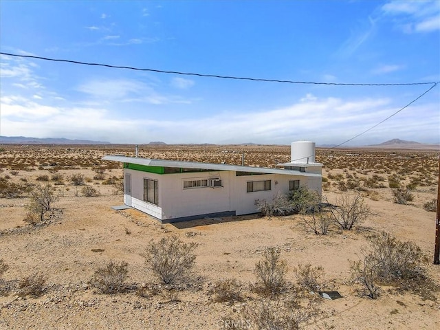 view of side of home featuring a mountain view and a rural view