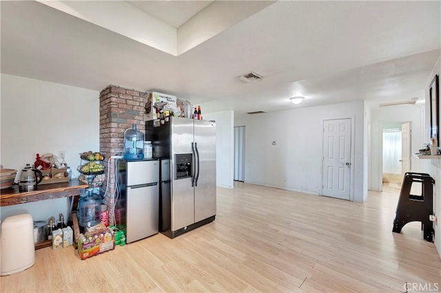 kitchen featuring stainless steel fridge with ice dispenser, stainless steel refrigerator, and light hardwood / wood-style flooring