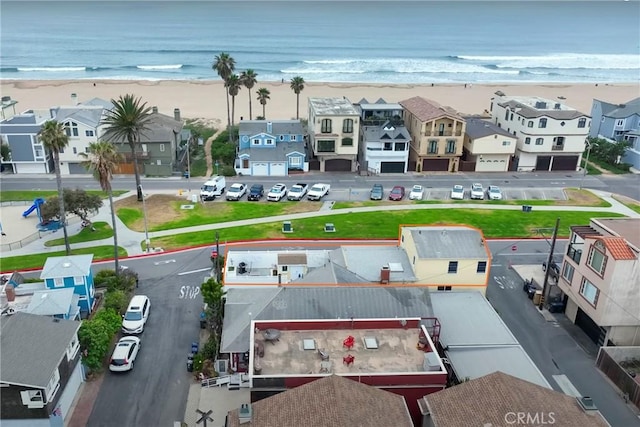 birds eye view of property with a view of the beach and a water view