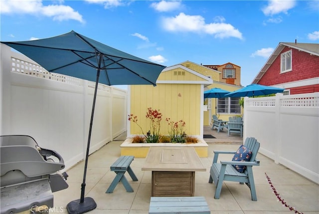 view of patio / terrace featuring a storage unit