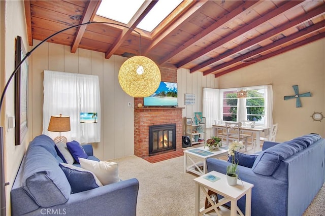 living room featuring carpet flooring, wood ceiling, a fireplace, and vaulted ceiling with skylight