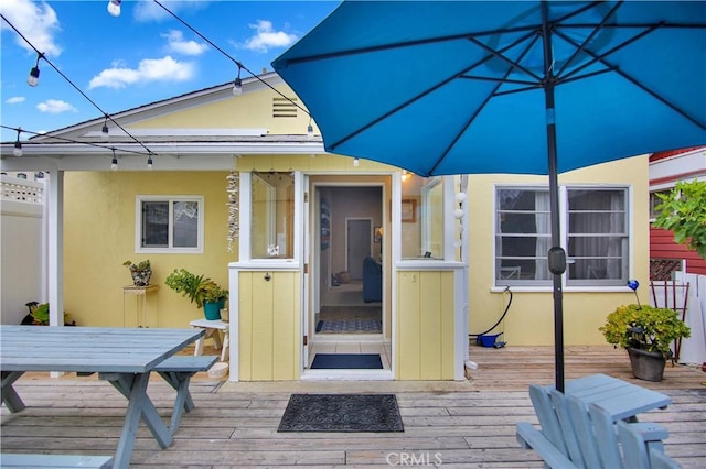 back of house featuring a wooden deck