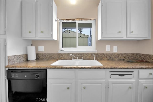 kitchen with dishwasher, white cabinetry, and sink