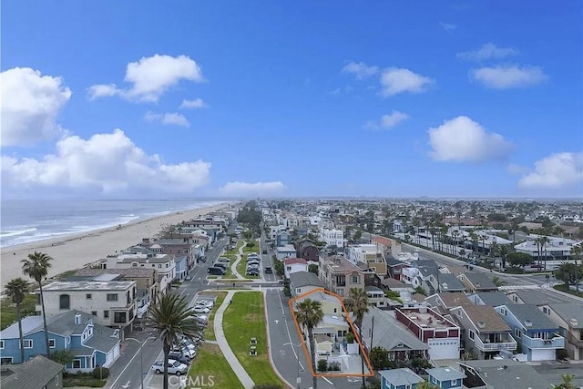 birds eye view of property featuring a beach view and a water view