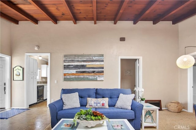 living room featuring beam ceiling, wooden ceiling, and hardwood / wood-style flooring