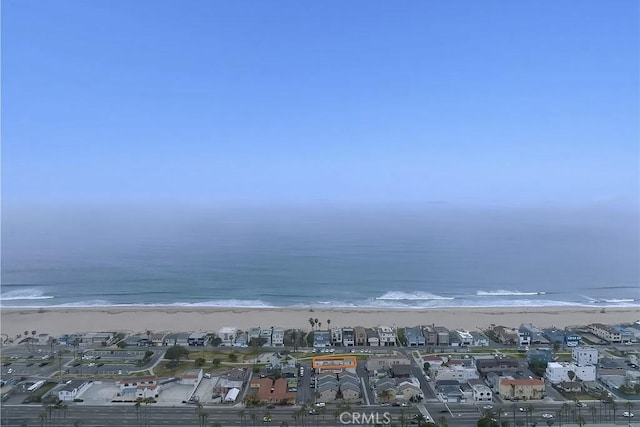 birds eye view of property with a water view and a view of the beach