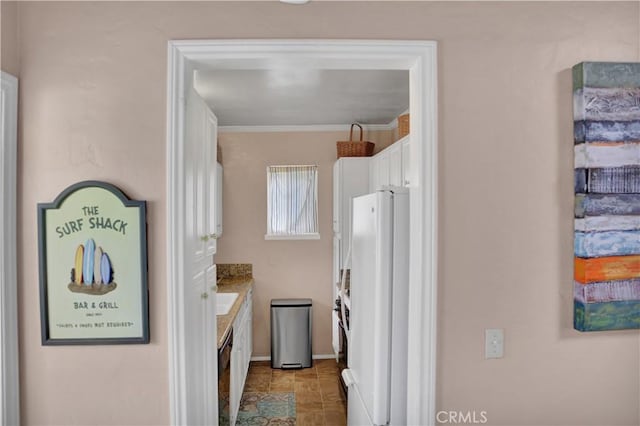 kitchen with white cabinetry, dishwasher, white fridge, and ornamental molding