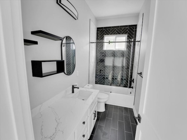 full bathroom featuring toilet, vanity, and tiled shower / bath