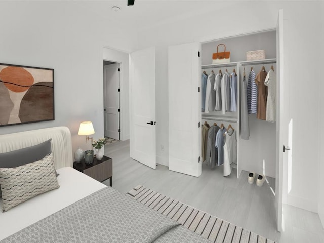 bedroom with a closet and light hardwood / wood-style floors