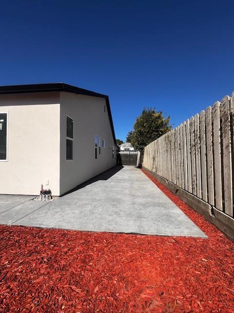 view of side of property with a patio