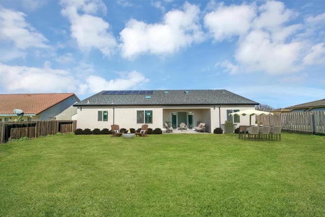 rear view of house featuring a lawn