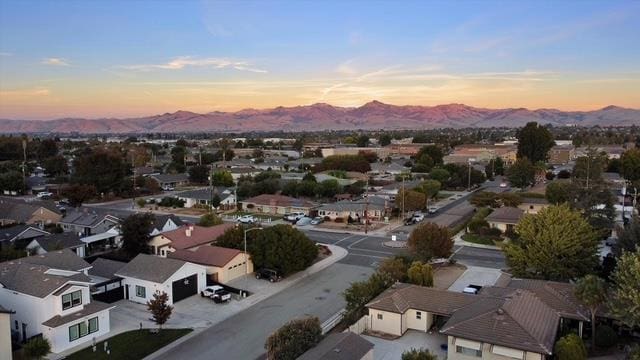 aerial view at dusk featuring a mountain view