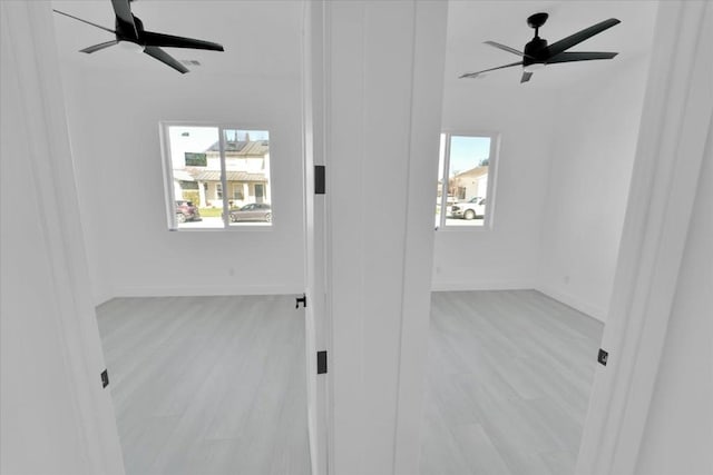 empty room featuring ceiling fan and light hardwood / wood-style flooring