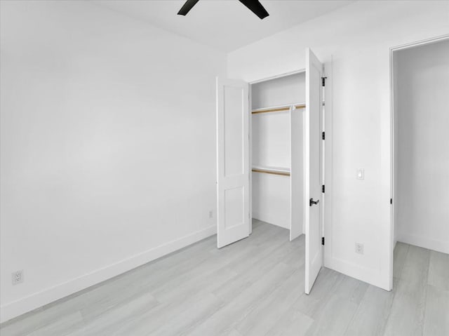 unfurnished bedroom with ceiling fan, a closet, and light hardwood / wood-style flooring