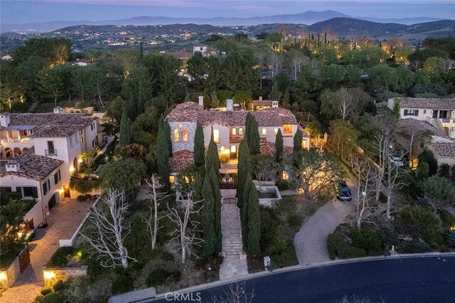 aerial view at dusk featuring a mountain view