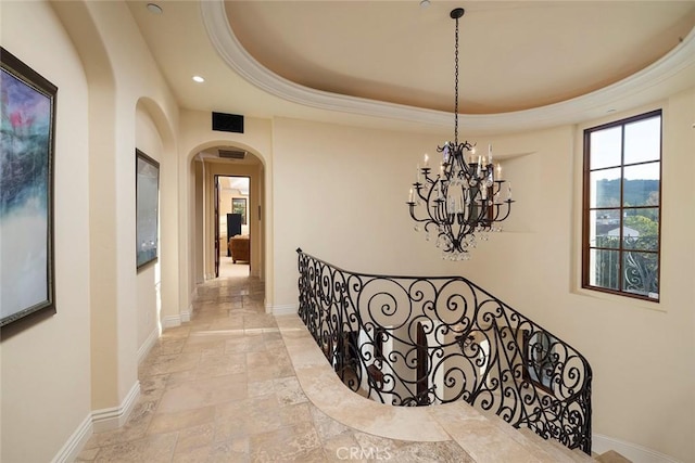 hallway featuring a raised ceiling