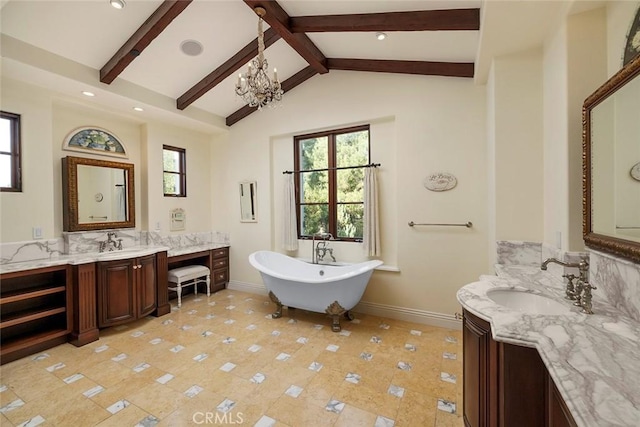 bathroom featuring lofted ceiling with beams, vanity, an inviting chandelier, and a bathtub