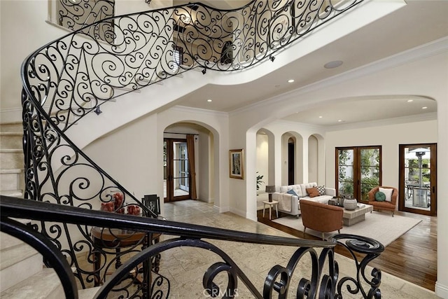 entryway featuring ornamental molding and french doors