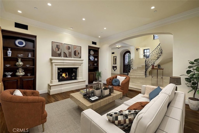 living room featuring ornamental molding, dark wood-type flooring, and built in features