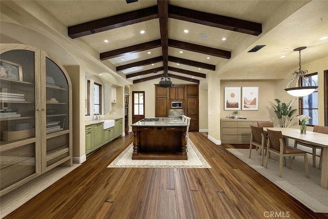 interior space featuring sink, dark wood-type flooring, and vaulted ceiling with beams