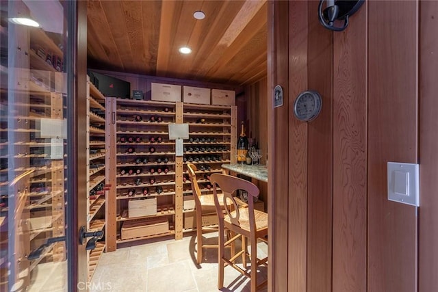 wine cellar with wooden ceiling and wood walls