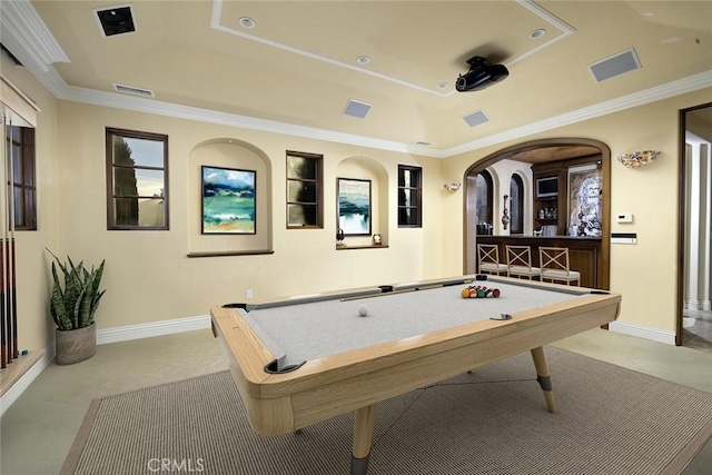 rec room with billiards, ornamental molding, a tray ceiling, and light carpet