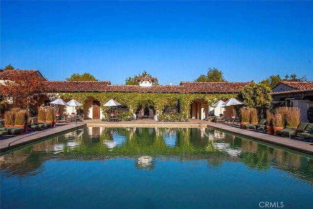 view of pool featuring a water view