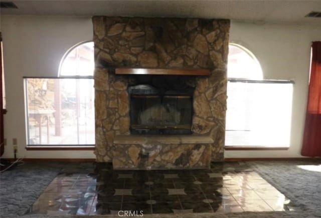 living room with a fireplace and a healthy amount of sunlight