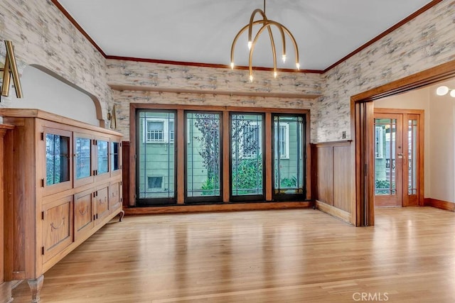 interior space featuring light hardwood / wood-style flooring, a healthy amount of sunlight, and crown molding