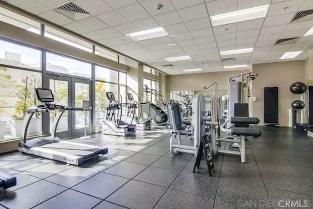 gym featuring french doors and a drop ceiling