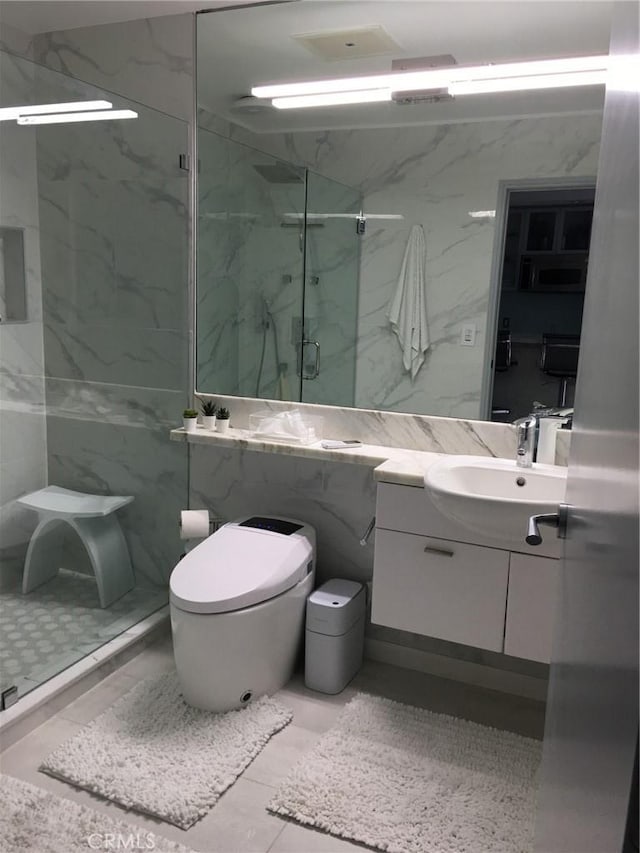 bathroom featuring tile walls, vanity, an enclosed shower, and toilet