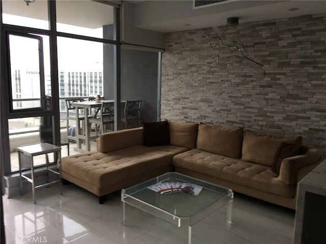 living room featuring tile patterned floors and floor to ceiling windows