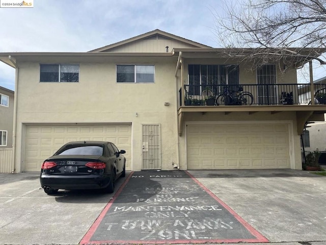 view of front of property with a balcony and a garage