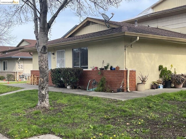 view of property exterior with a yard