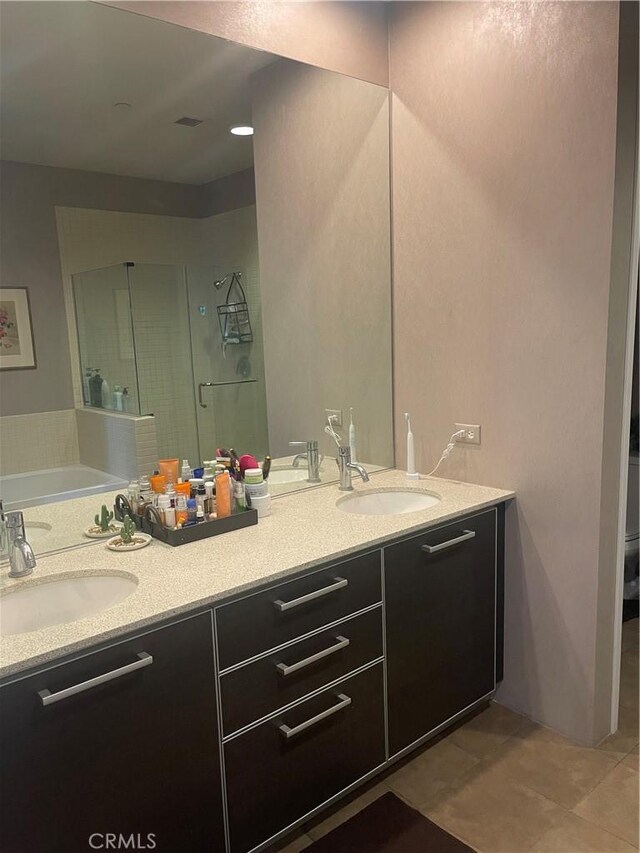 bathroom with plus walk in shower, tile patterned floors, and vanity