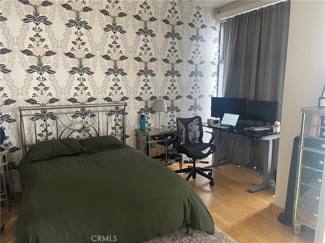 bedroom with wood-type flooring