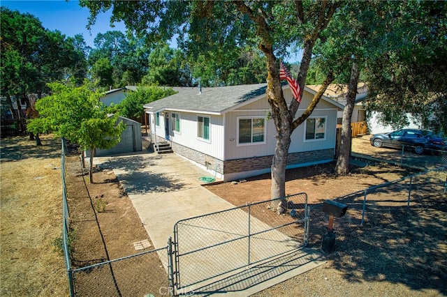 view of front of house with a garage and an outbuilding