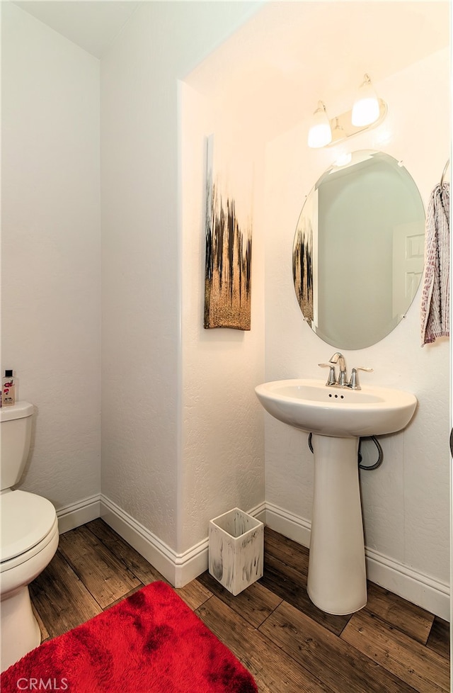 bathroom featuring toilet and hardwood / wood-style flooring