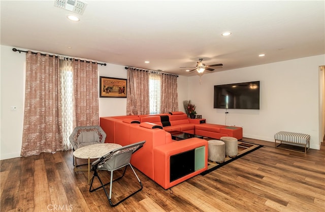 living room featuring hardwood / wood-style floors and ceiling fan