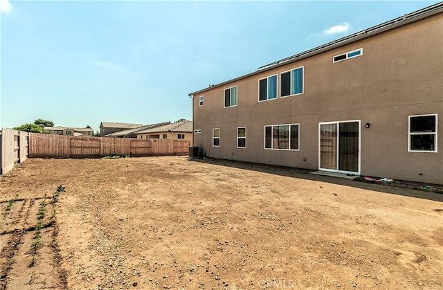 rear view of property featuring central AC unit