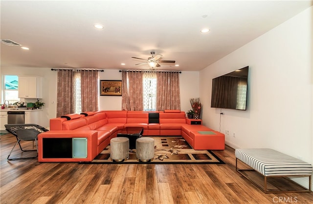 living room featuring hardwood / wood-style floors, ceiling fan, and plenty of natural light