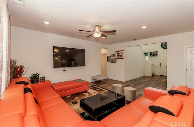 living room featuring ceiling fan and dark hardwood / wood-style flooring