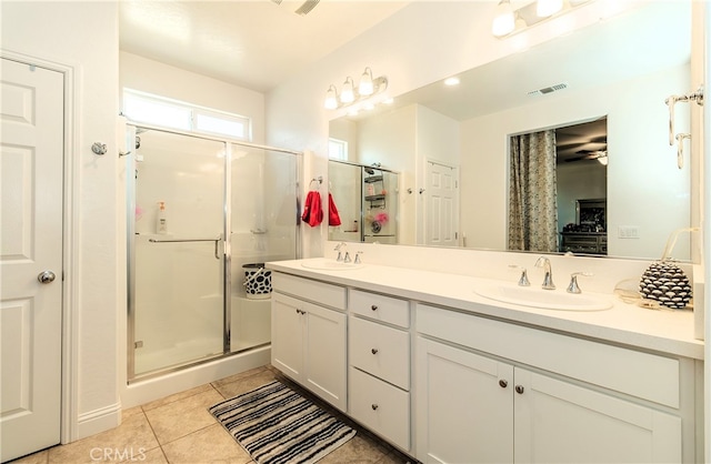 bathroom with vanity, tile patterned floors, ceiling fan, and an enclosed shower