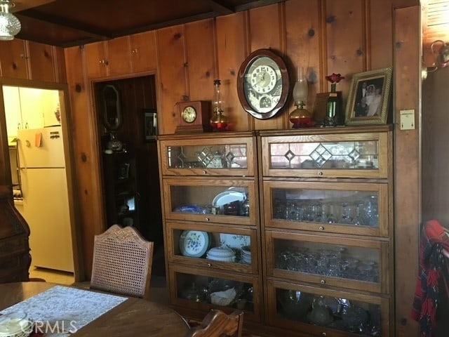 interior space with wooden walls and white refrigerator