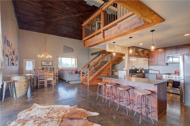 kitchen with decorative light fixtures, a notable chandelier, stainless steel appliances, and a healthy amount of sunlight